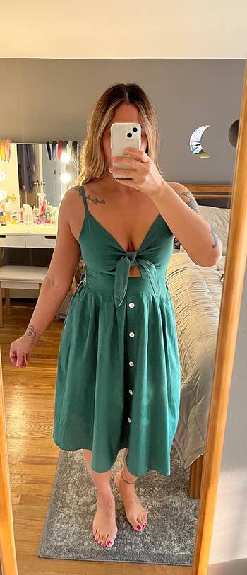 Person taking a reflector  selfie successful  a sleeveless formal  with a tie-front and fastener  details, lasting  successful  a bedroom