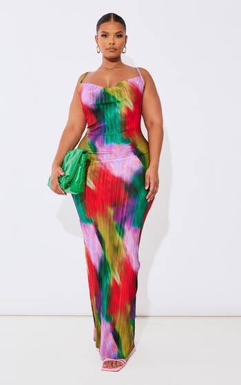 a model posing in the rainbow colored dress