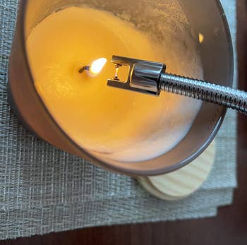 close-up of reviewer lighting a candle with the electric lighter