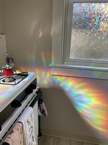 Reviewer's window pane is covered in the film, which results in a rainbow being cast against a wall