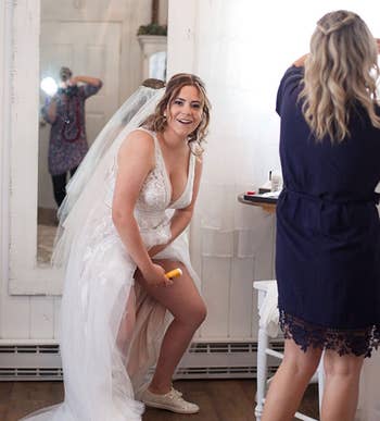 reviewer applying the stick to their leg while wearing a wedding dress