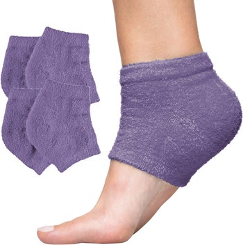 A moisturizing heel sock on a models foot