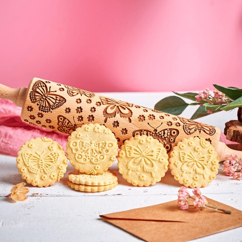 cookies with a butterfly design that was created with the rolling pin
