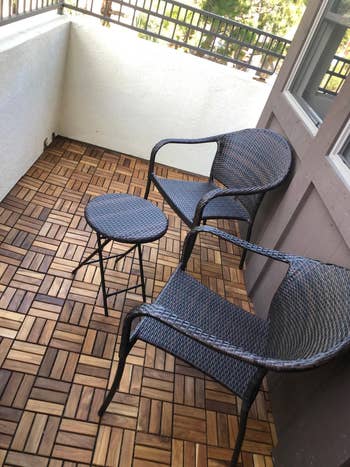Two wicker chairs and a tiny circular array connected a balcony with a patterned woody floor, perfect for outdoor relaxation oregon decor inspiration