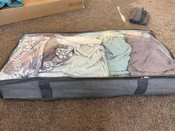 Clothing retention container filled with folded garments