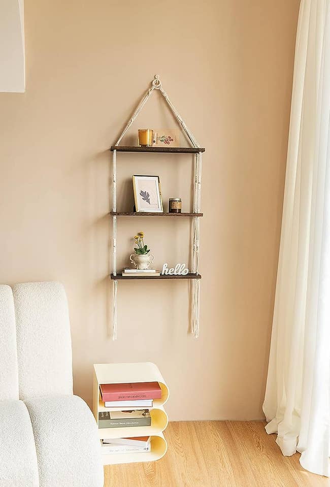 Wall-mounted shelving with decorative items and books next to a white sofa
