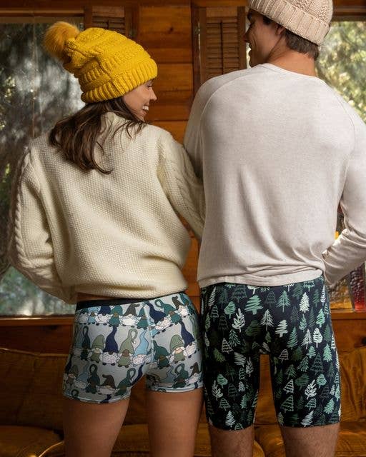 two models, one wearing gnome-printed boyshorts and the other wearing tree-print boxer briefs