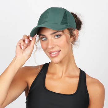 travel Person wearing a stylish athletic cap and a sporty tank top, smiling at the camera