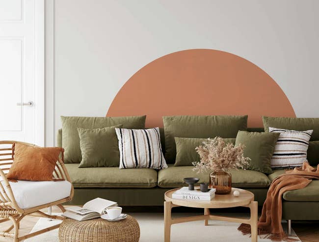 large orange wall mural above couch