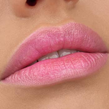 Close-up of a person’s lips wearing pink lipstick