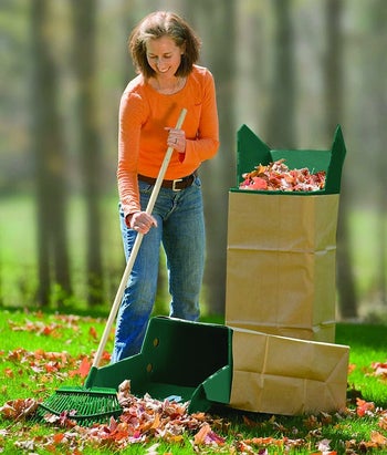 model raking leaves next to a brown waste bag propped up with the leaf chute