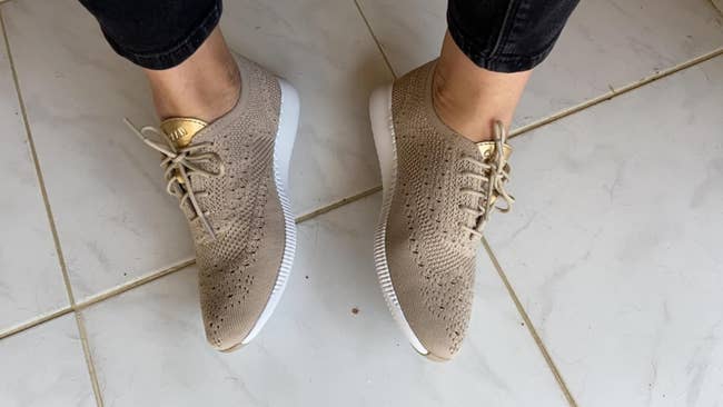 reviewer standing in new tan and gold sneakers suitable for a casual outfit