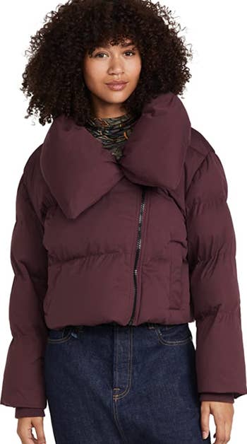 a model wearing the jacket in merlot paired with dark jean
