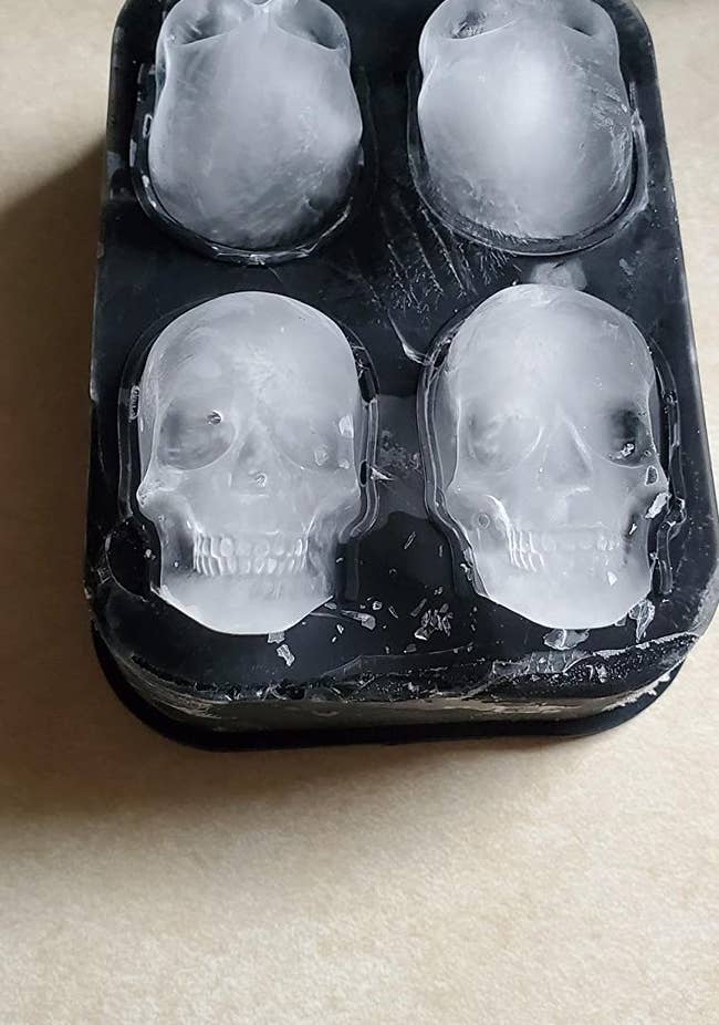 reviewer photo of four skull-shaped ice cubes in the mold