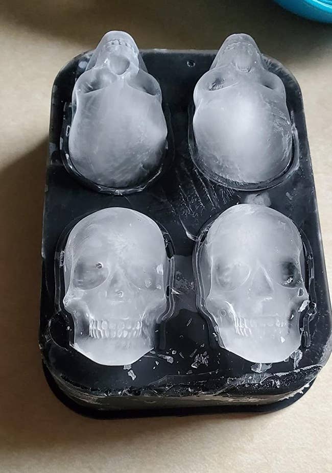 reviewer photo of four skull-shaped ice cubes in the mold