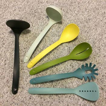 A reviewer's set in shades of green and yellow laid out to show all the utensils 