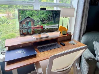 Reviewer's photo of desk with monitor and laptop top