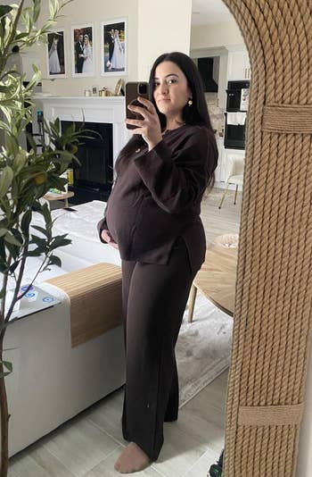 Person successful a cozy location setting, wearing a comfy loungewear set, taking a reflector selfie