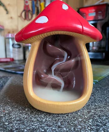 Mushroom-shaped incense burner with swirling smoke inside