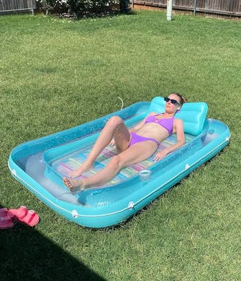 Person relaxing connected an inflatable excavation float