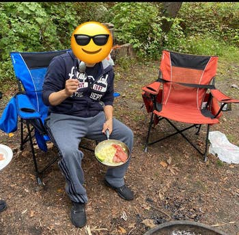 reviewer photo sitting in camping chair around fire pit