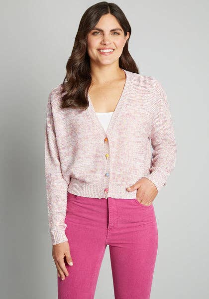 model in pink v neck cardigan with different color ice cream buttons