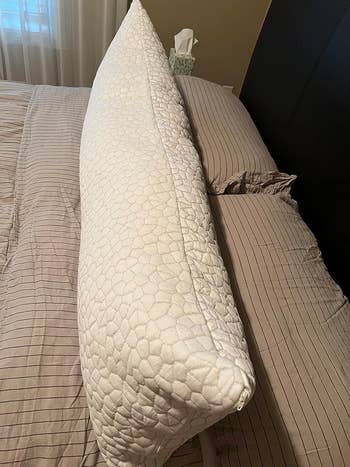 image of the body pillow on a bed