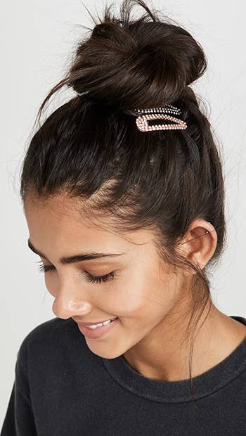 model wearing two clips at the base of a bun