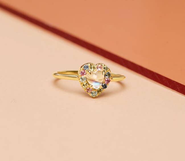 the ring with a heart center and multicolored jewels framing the heart