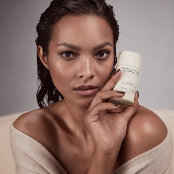 model holding the deodorant tube