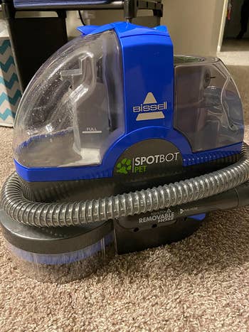 A reviewer's vacuum on the carpet 