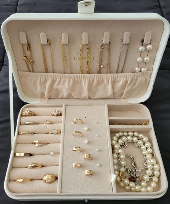 reviewer photo of an open jewelry case full of different pieces of jewelry 