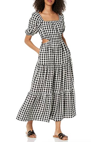 model wearing the black and white gingham dress with sandals