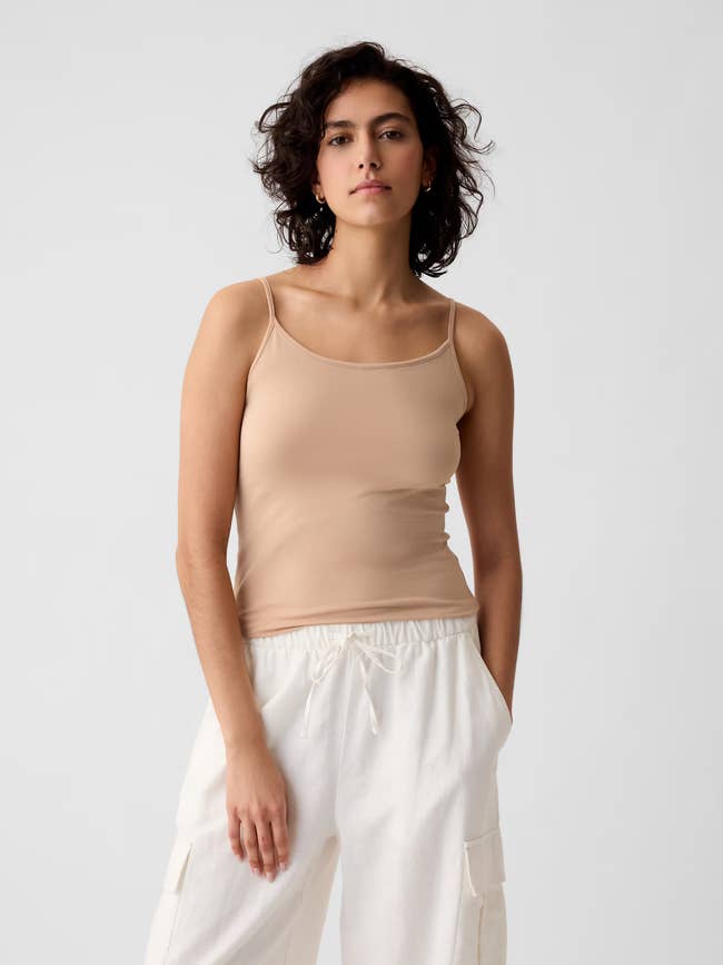 Person successful a neutral vessel apical and achromatic cargo pants poses confidently, hands successful pockets