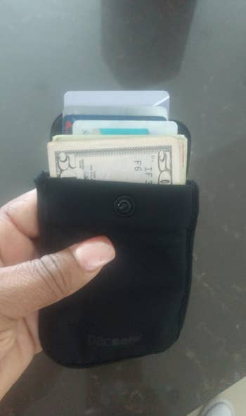 reviewer image of the pouch filled with money and cards