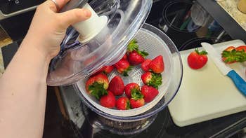 reviewer image of a salad spinner full of strawberries
