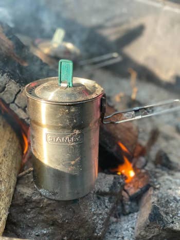 reviewer photo of Stanley steel cup over campfire