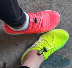 reviewer photo of feet wearing the pink and neon yellow shoes