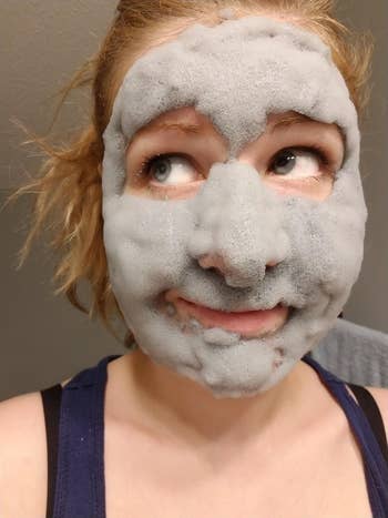 A reviewer with a bubbly face mask