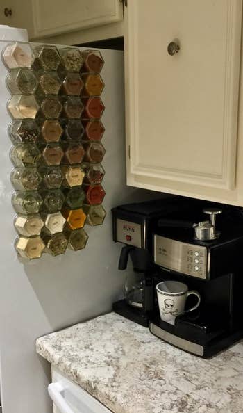 different reviewer's setup with large spice jars arranged on side of fridge