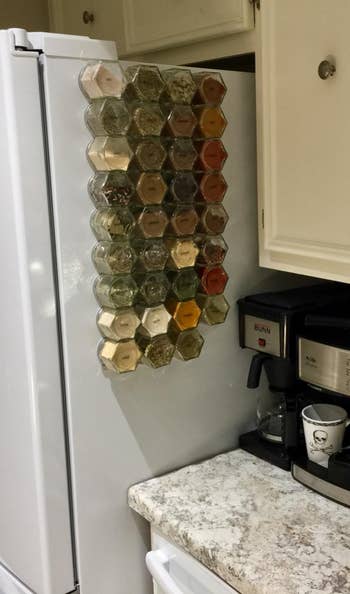 different reviewer's setup with large spice jars arranged on side of fridge