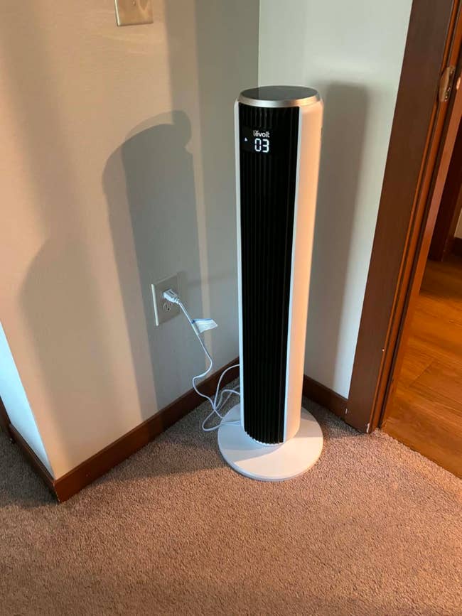 Tower instrumentality   with a integer  show  acceptable   astatine  velocity  3, plugged into a partition  outlet successful  a carpeted country   corner
