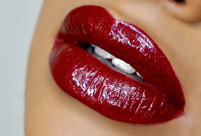 a model wearing a sparkly red lip