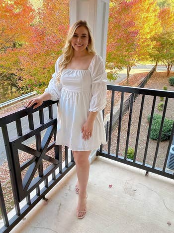 A reviewer wearing the dress on-the-shoulders in white