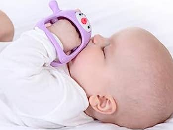 A baby sucking on the pacifier 