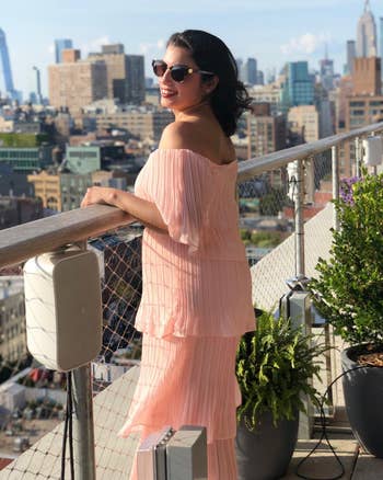 side view of reviewer wearing the pink dress