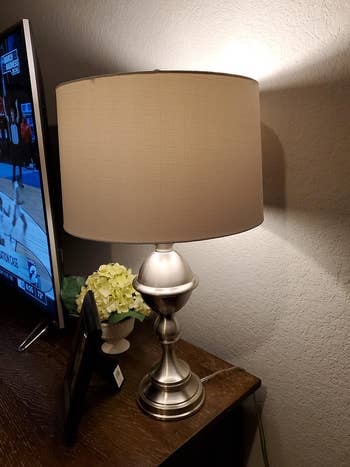 a reviewer's table lamp with the color-changing smart bulb
