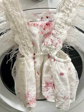reviewer image of a child's white dress covered in purple stains