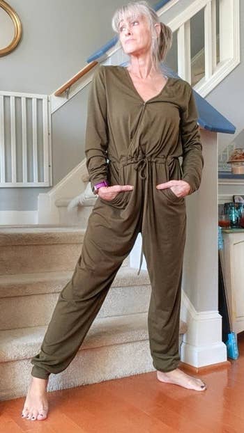 personal in an olive jumpsuit
