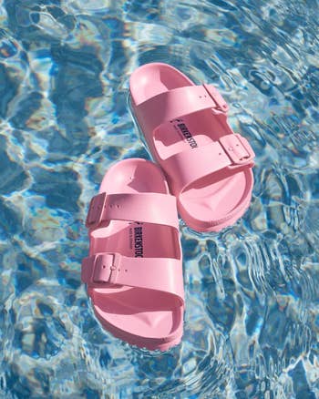 Pink sandals floating on clear water
